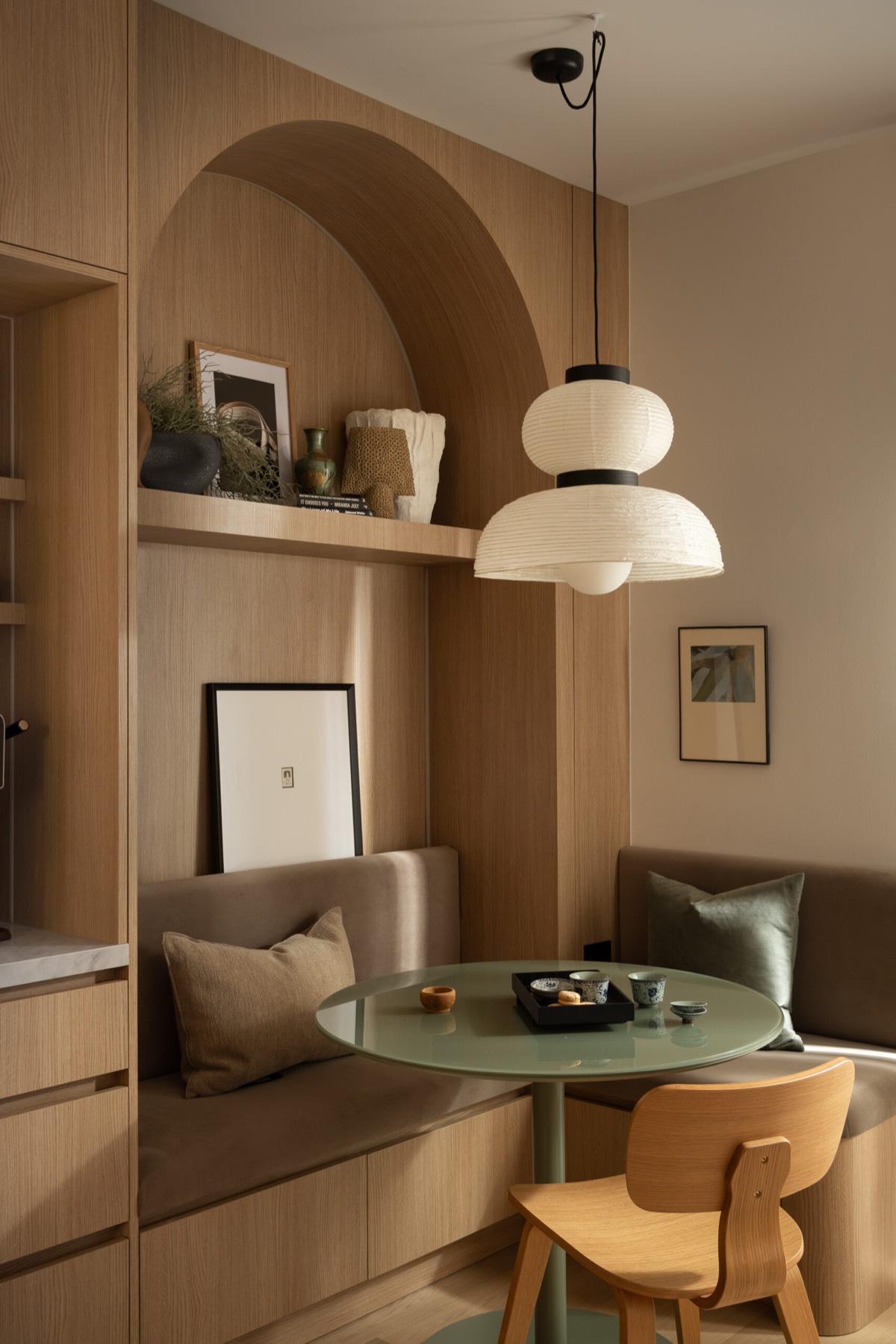 Arched oak banquette with paper pendant, David Dunlap Circle Residence by Estee Design